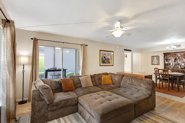 living room with light hardwood / wood-style flooring and ceiling fan