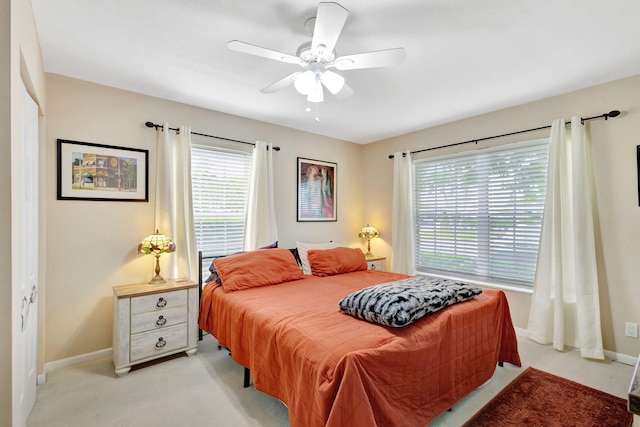 carpeted bedroom featuring a closet and ceiling fan