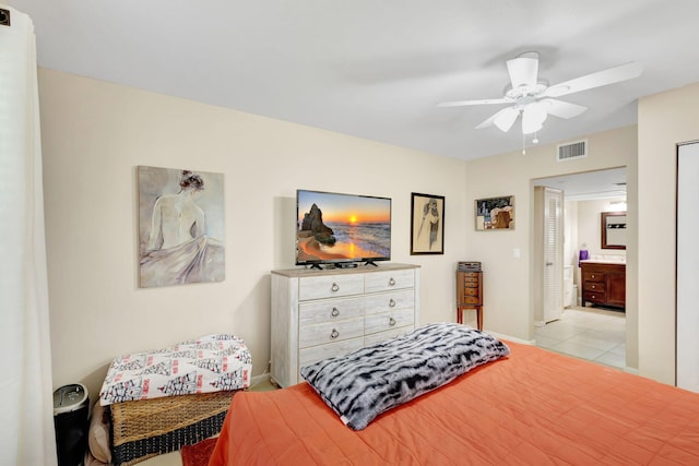 tiled bedroom featuring connected bathroom and ceiling fan