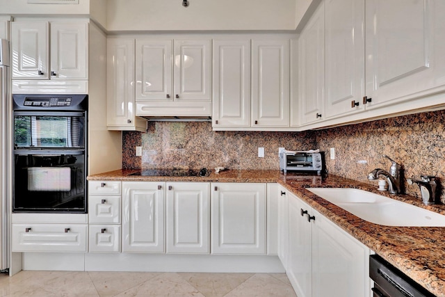 kitchen with black appliances, sink, backsplash, dark stone counters, and white cabinets