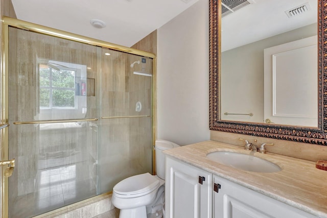 bathroom with vanity, toilet, and an enclosed shower