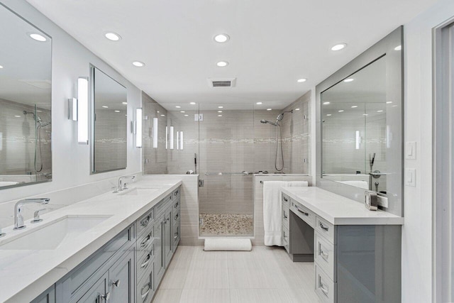 bathroom featuring a shower with door and vanity