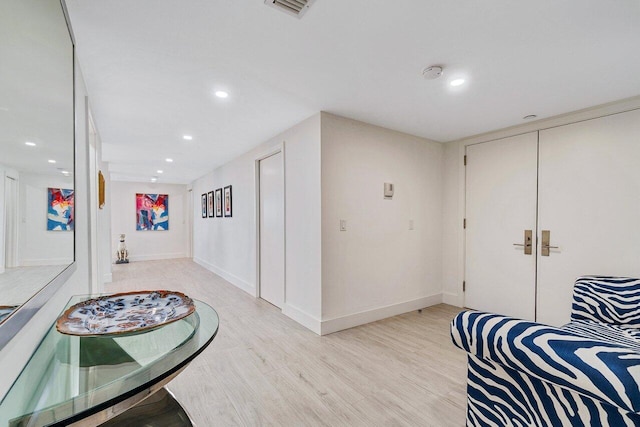 hall with light hardwood / wood-style flooring