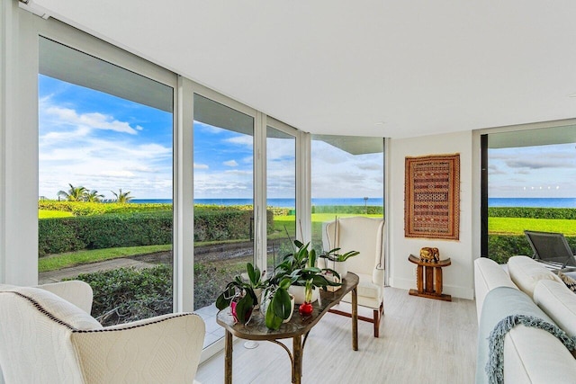 sunroom featuring a water view and plenty of natural light