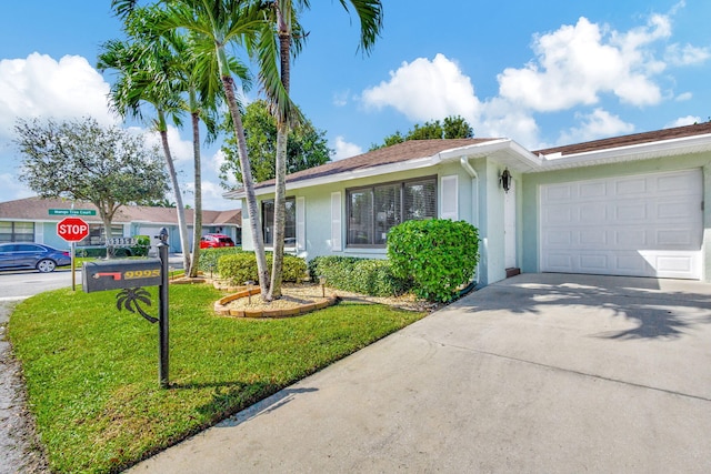 single story home with a front yard and a garage