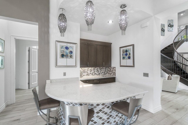 dining area with a chandelier and light hardwood / wood-style floors