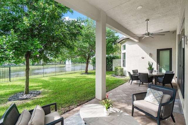 view of patio / terrace with a water view and ceiling fan