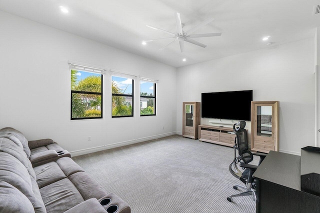 carpeted office space with ceiling fan