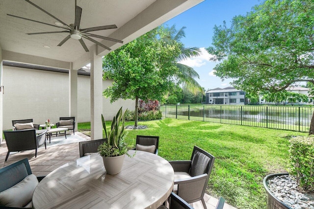 view of patio with an outdoor hangout area, a water view, and ceiling fan