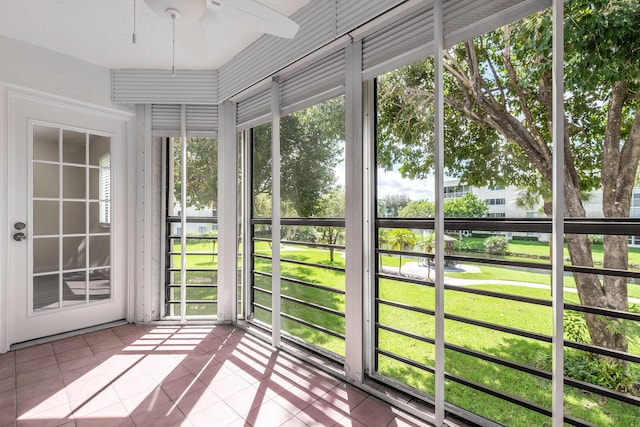 unfurnished sunroom with a wealth of natural light and ceiling fan