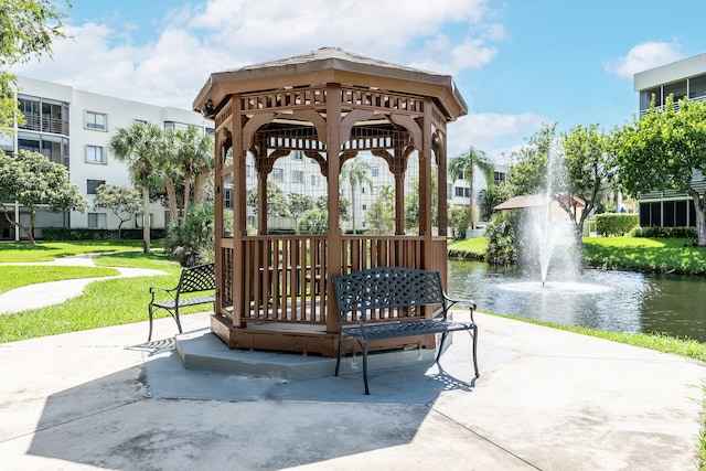 view of property's community featuring a gazebo, a lawn, and a water view