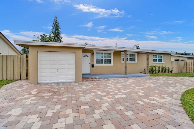 ranch-style house with a front yard and a garage