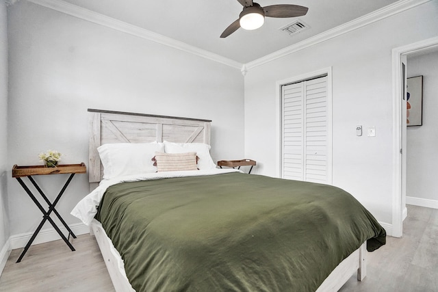 bedroom featuring light hardwood / wood-style flooring, ornamental molding, and ceiling fan