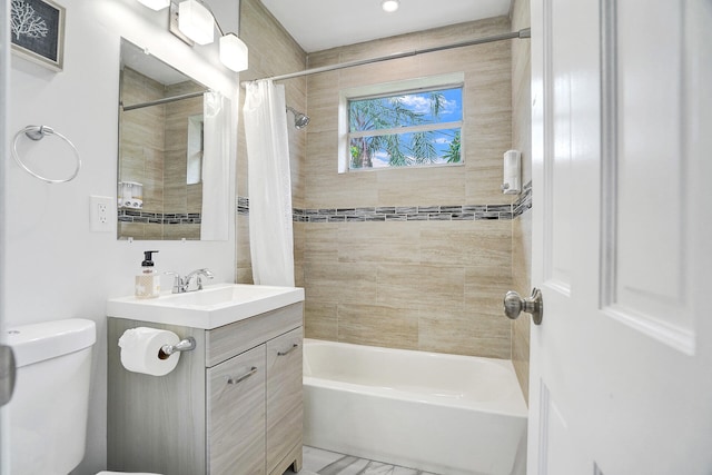 full bathroom with vanity, shower / tub combo, and toilet