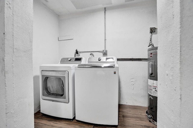 laundry room with separate washer and dryer and dark hardwood / wood-style flooring