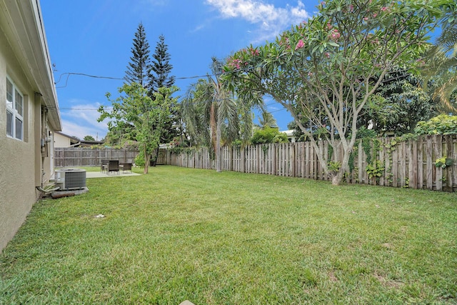 view of yard featuring central AC unit and a patio area