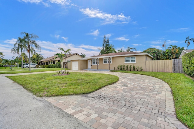 ranch-style home with a garage and a front lawn