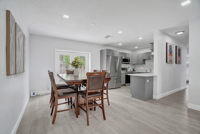 dining area featuring light wood-type flooring