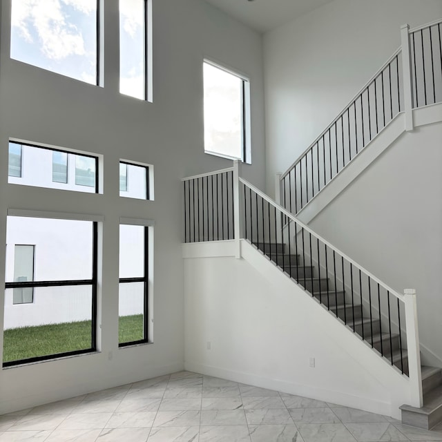 staircase featuring a high ceiling