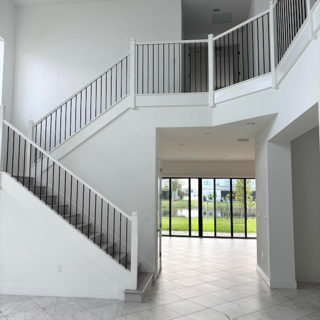 stairs featuring a high ceiling