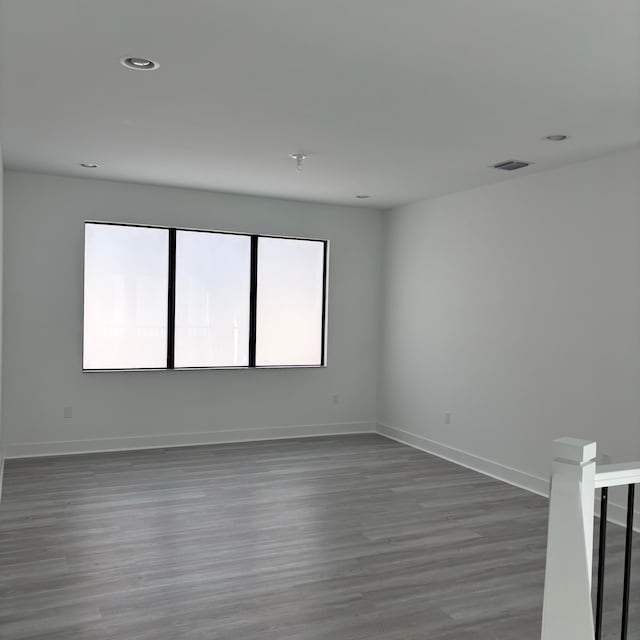 empty room with dark wood-type flooring