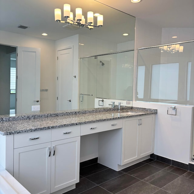 bathroom with vanity and a shower with door