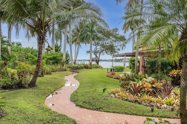 view of home's community with a lawn and a water view