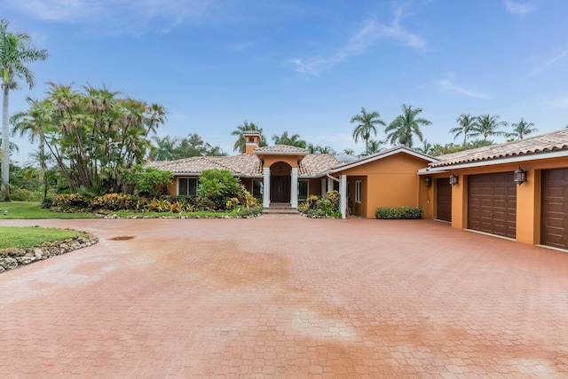 mediterranean / spanish-style home featuring a garage