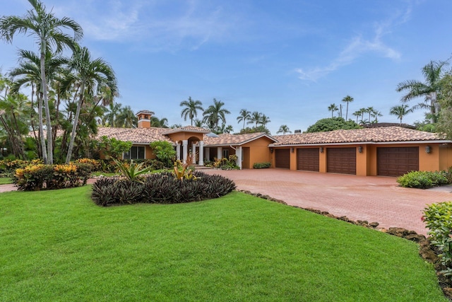 view of front of house featuring a front yard and a garage