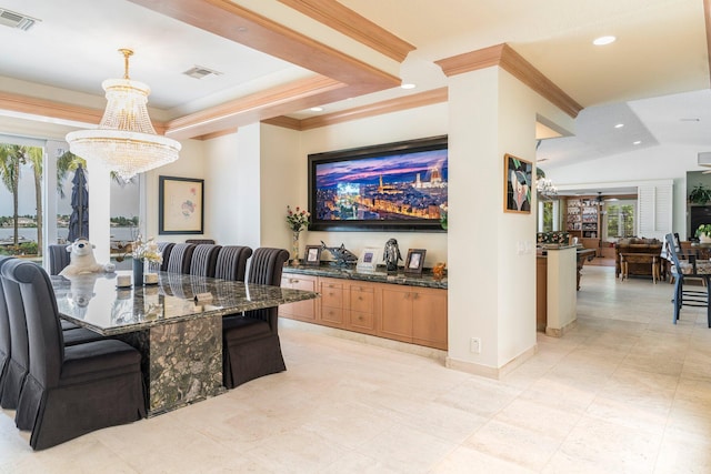 dining area featuring ceiling fan with notable chandelier and crown molding