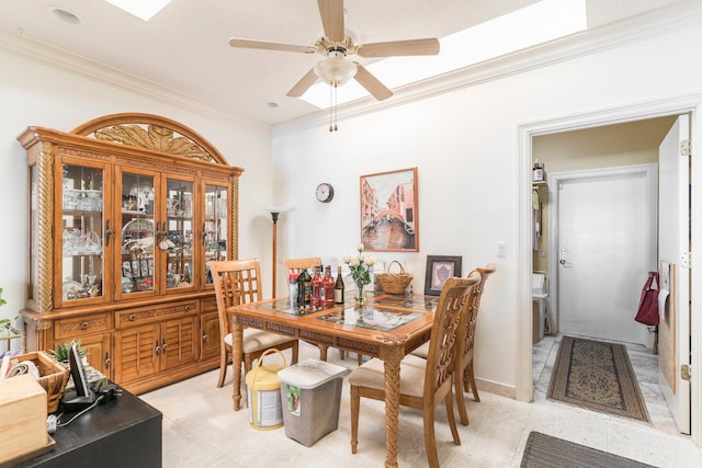 dining space with crown molding and ceiling fan