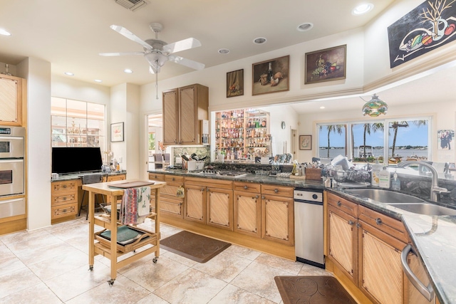 kitchen with sink, ceiling fan, light tile patterned floors, tasteful backsplash, and stainless steel appliances