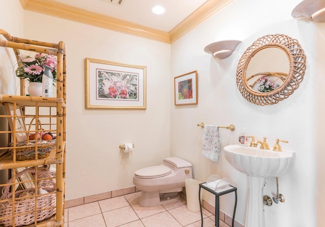 bathroom with tile patterned flooring, toilet, and ornamental molding