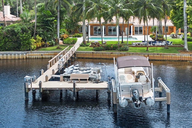 dock area with a water view and a patio