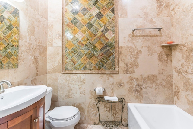 bathroom featuring a bathing tub, vanity, tile walls, and toilet