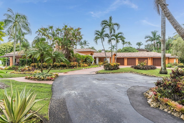 view of front facade featuring a front yard and a garage