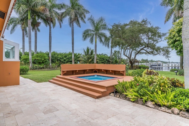 view of pool featuring a yard, an in ground hot tub, and a patio