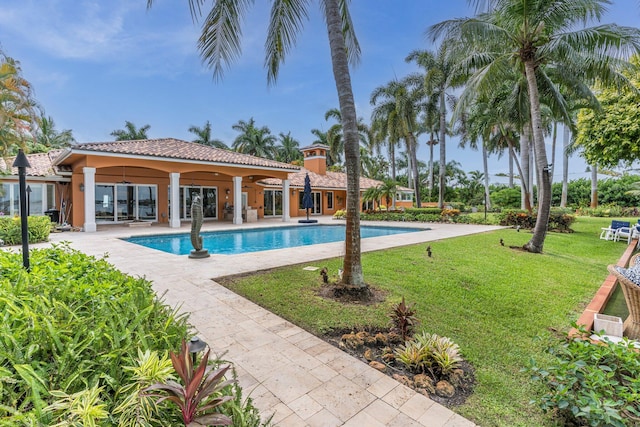 view of pool with a lawn and a patio area