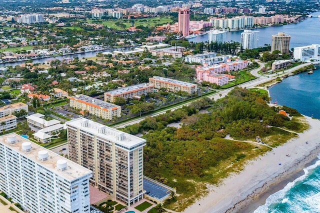 bird's eye view with a water view and a beach view