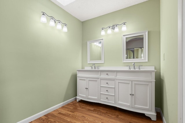 bathroom featuring vanity, hardwood / wood-style flooring, and a textured ceiling