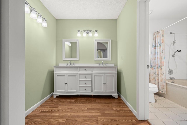 full bathroom with toilet, a textured ceiling, vanity, shower / bath combo, and hardwood / wood-style flooring