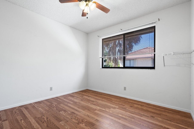 spare room featuring ceiling fan, hardwood / wood-style floors, and a textured ceiling