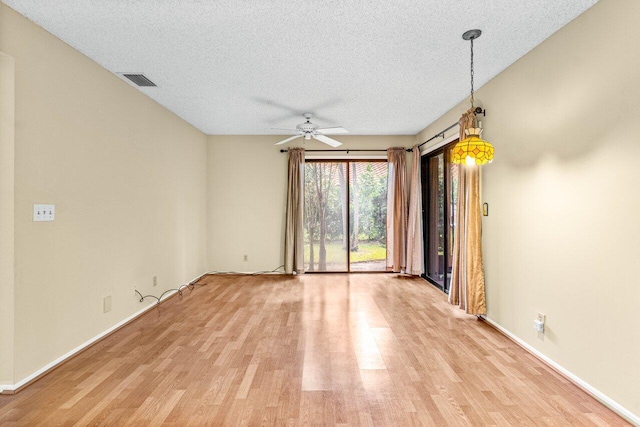 unfurnished room featuring ceiling fan, a textured ceiling, and light wood-type flooring