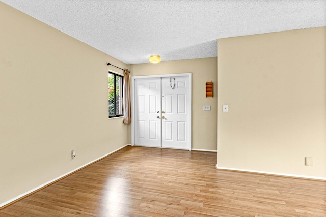 interior space featuring light hardwood / wood-style flooring and a textured ceiling