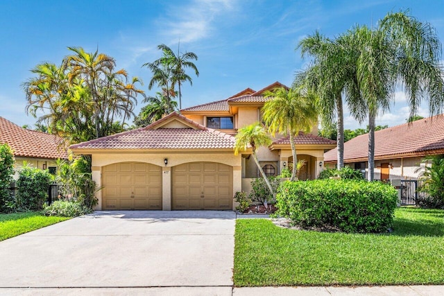 mediterranean / spanish home featuring a garage and a front lawn