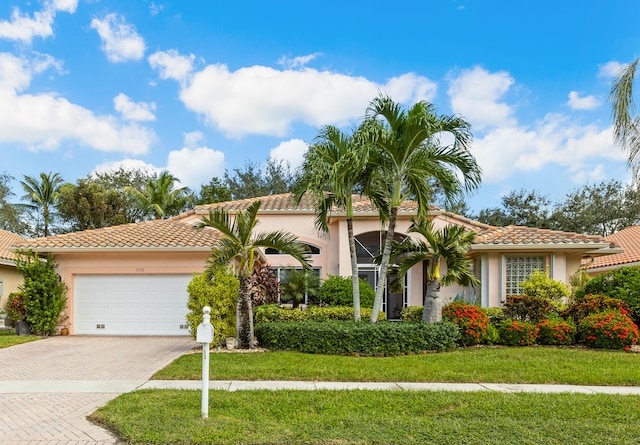 mediterranean / spanish-style home with a front lawn and a garage