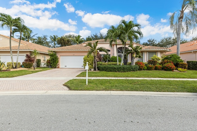 view of front of property with a front lawn and a garage