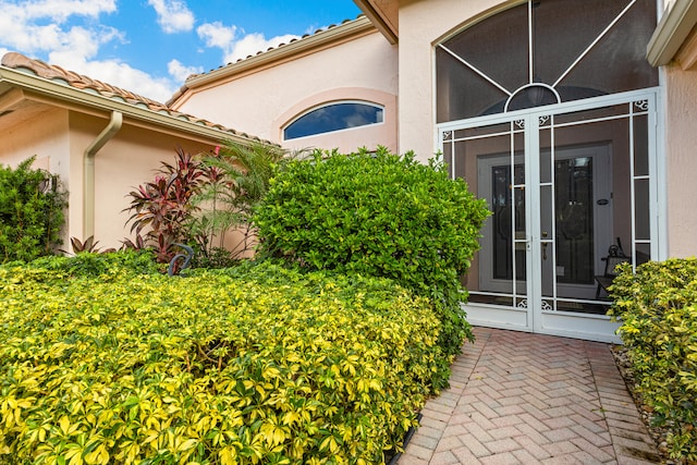 view of exterior entry featuring french doors