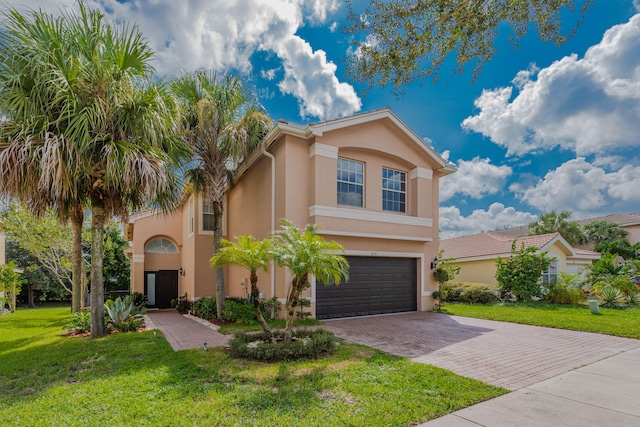 view of front of house featuring a front yard and a garage