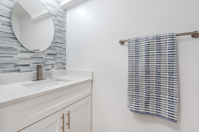 bathroom featuring vanity and decorative backsplash